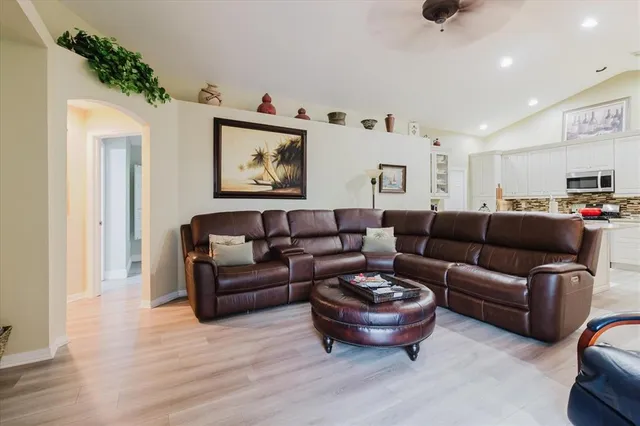 a living room with furniture and a painting on the wall