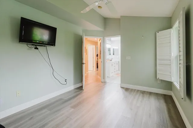 a view of a livingroom with wooden floor and a flat screen tv