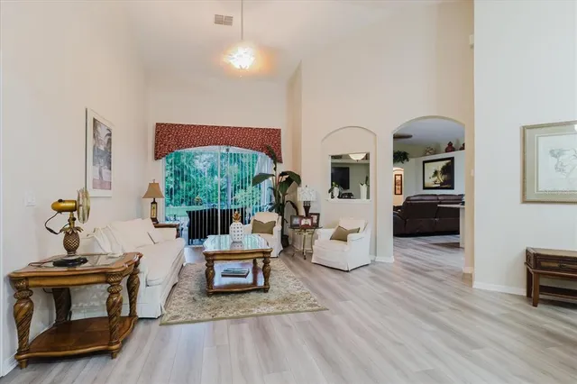 a living room with furniture and wooden floor
