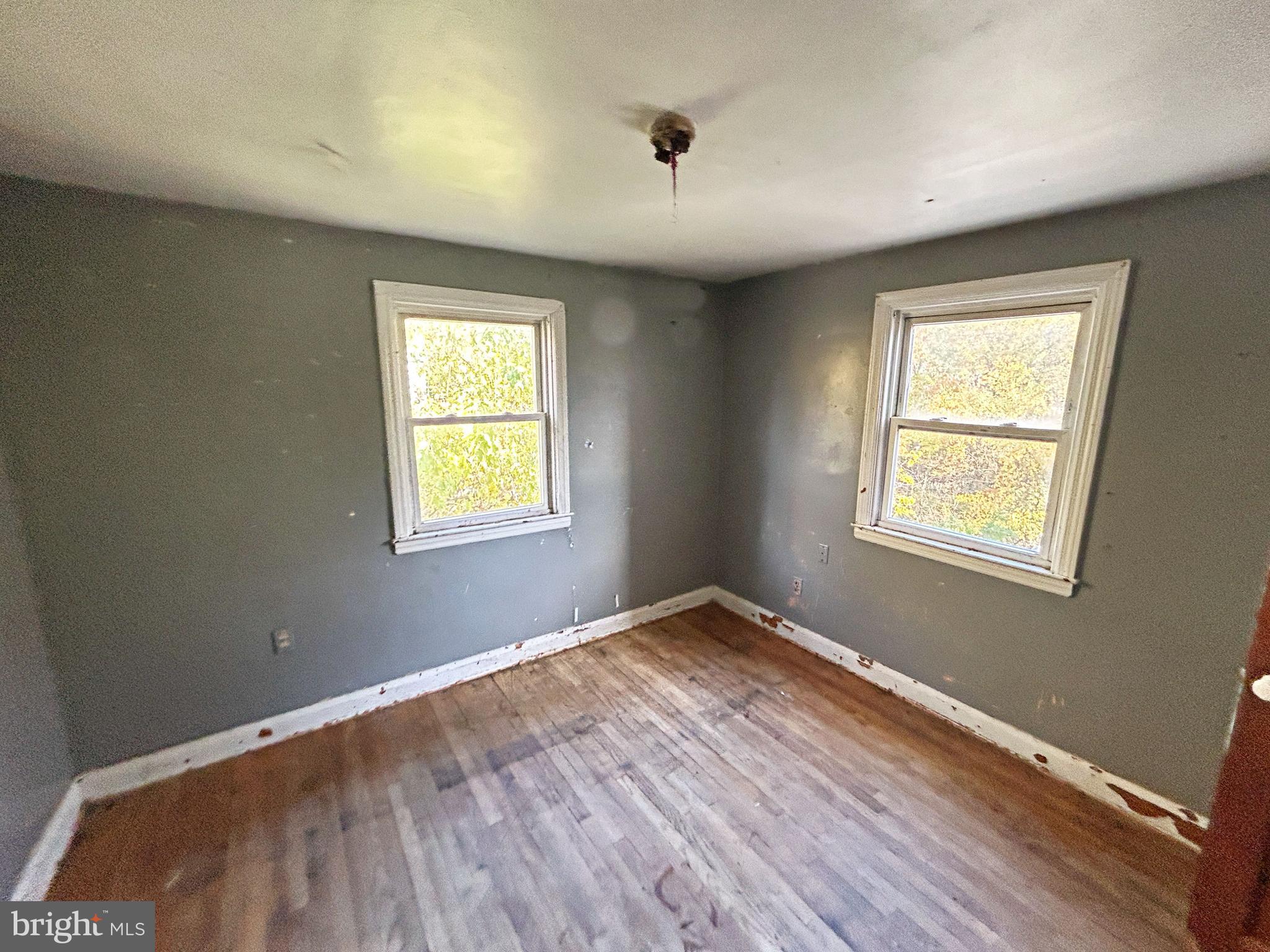 4407 Ridge Drive Baltimore, MD 21229 - Photo 15 of 18 a view of an empty room with wooden floor and a window