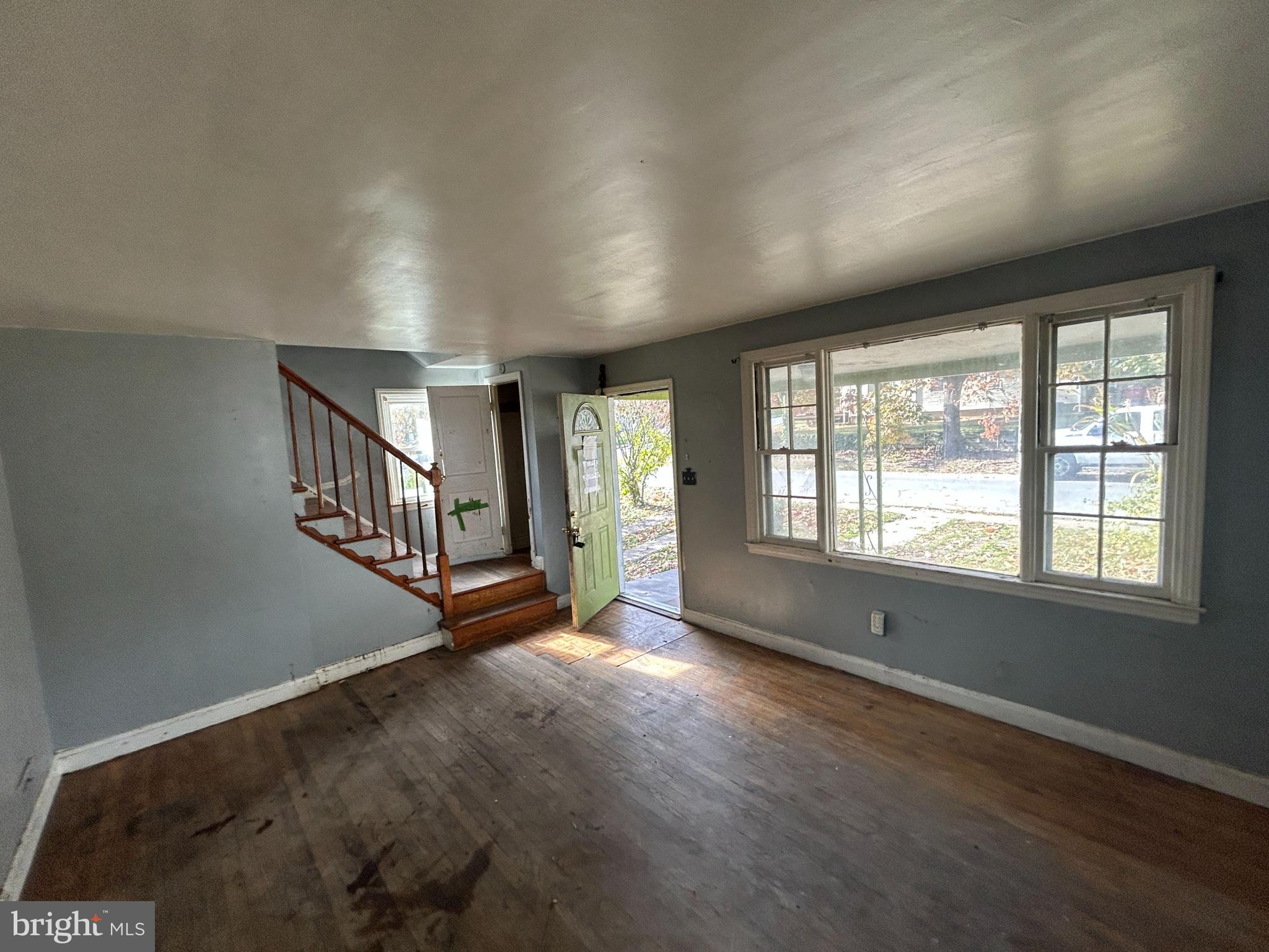 4407 Ridge Drive Baltimore, MD 21229 - Photo 7 of 18 a view of an empty room with wooden floor and a window
