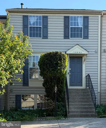 a front view of a house with plants