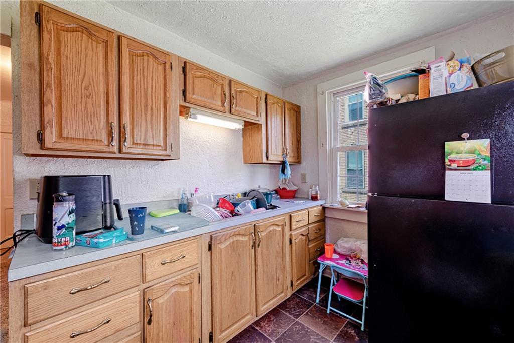 125 North Chestnut Street Butler, PA 16001 - Photo 11 of 25 a kitchen with a refrigerator and cabinets