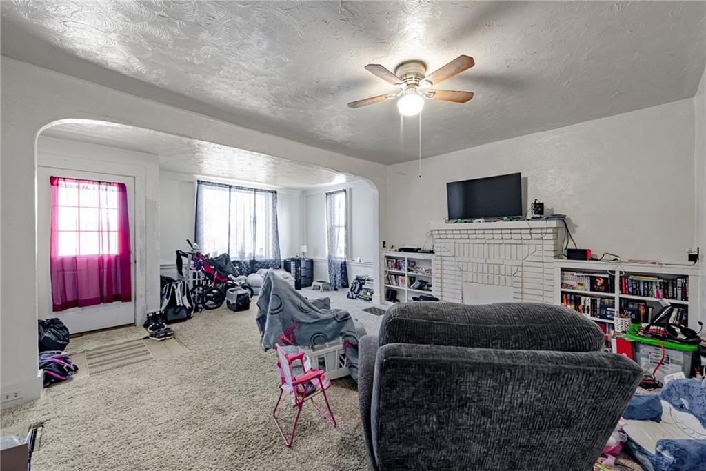 125 North Chestnut Street Butler, PA 16001 - Photo 4 of 25 a living room with furniture a flat screen tv and a window