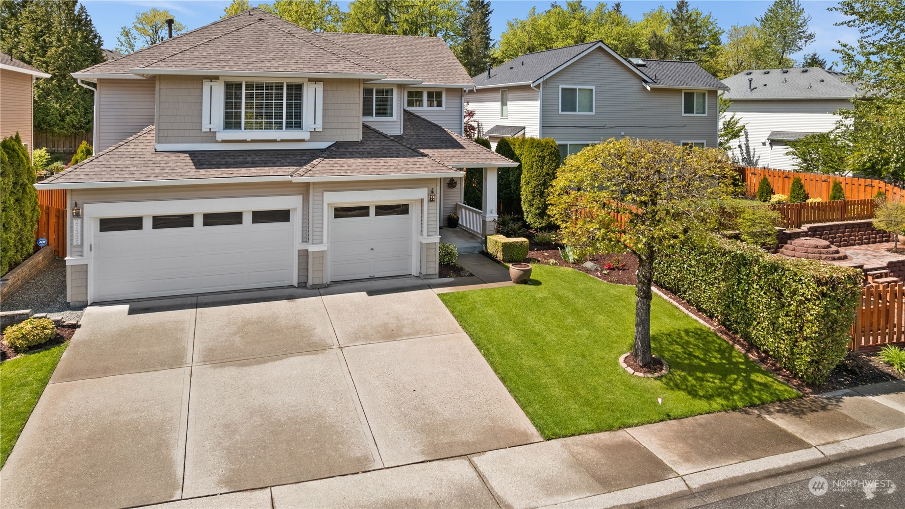 a front view of a house with a yard and trees