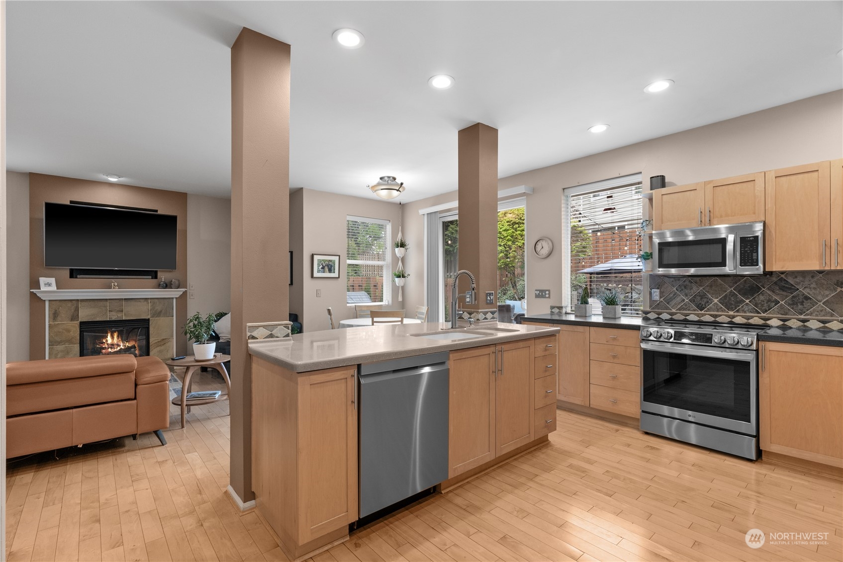 27325 Maple Ridge Way Southeast Maple Valley, WA 98038 - Photo 13 of 40 a kitchen with stainless steel appliances granite countertop a stove and a sink