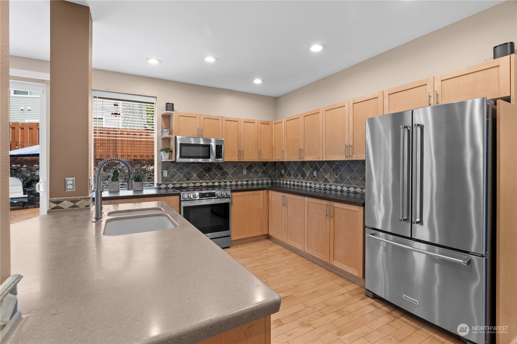 27325 Maple Ridge Way Southeast Maple Valley, WA 98038 - Photo 14 of 40 a kitchen with stainless steel appliances granite countertop a refrigerator a sink a stove and oven