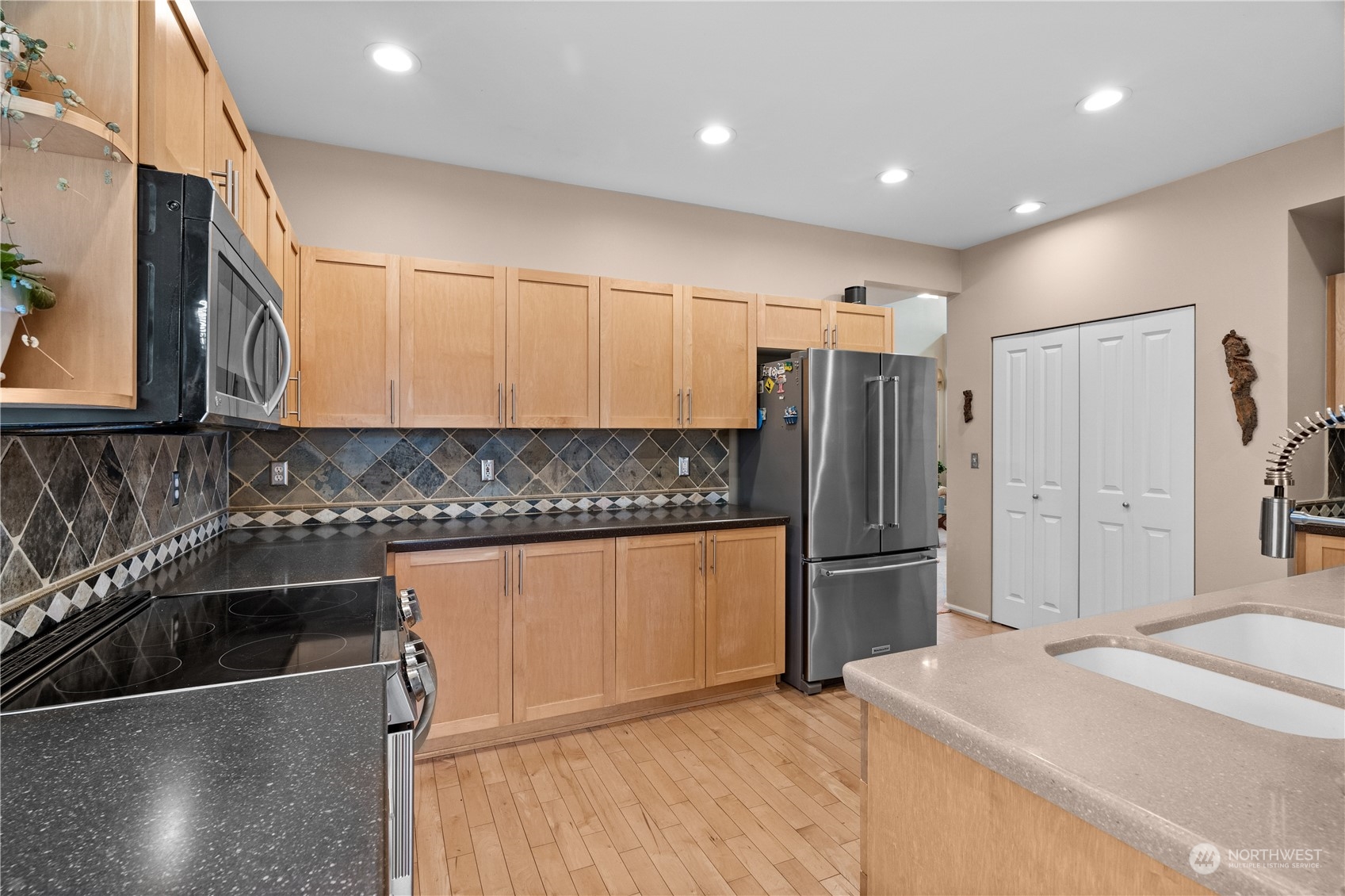 27325 Maple Ridge Way Southeast Maple Valley, WA 98038 - Photo 15 of 40 a kitchen with a refrigerator sink and cabinets