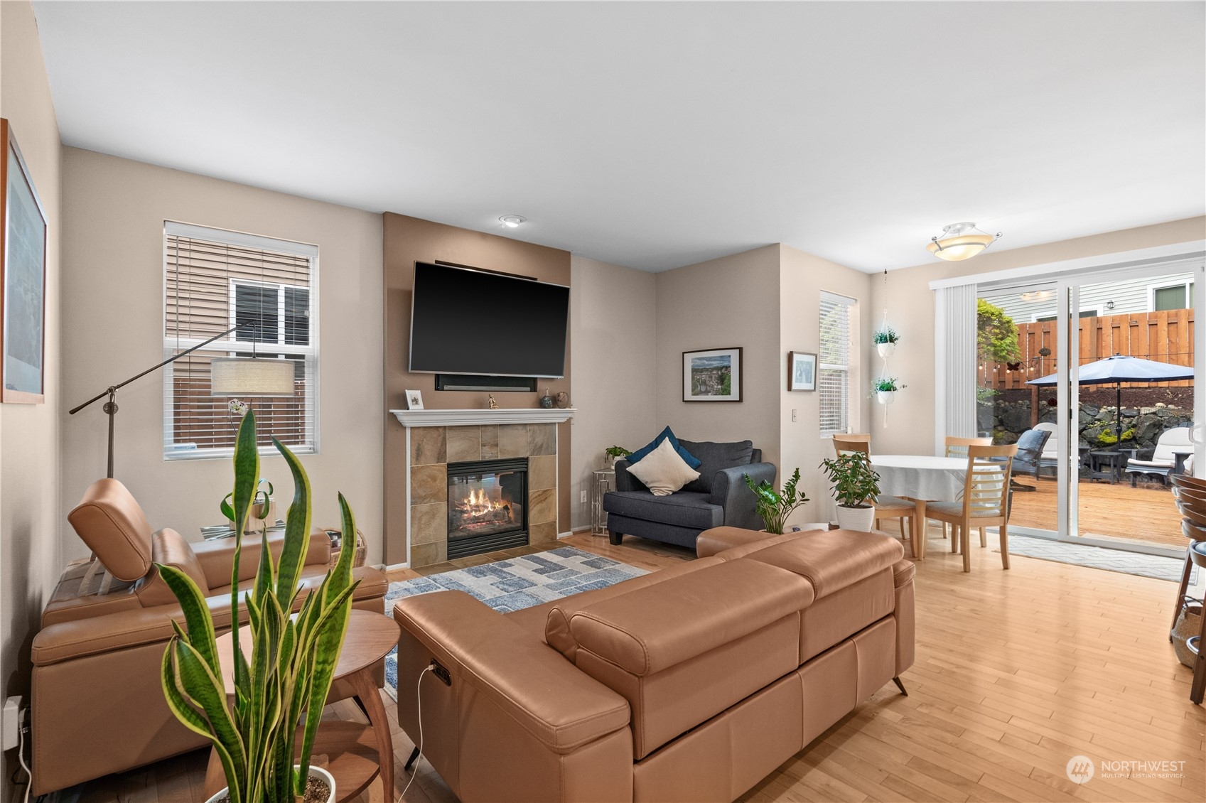 27325 Maple Ridge Way Southeast Maple Valley, WA 98038 - Photo 18 of 40 a living room with furniture a flat screen tv and a fireplace