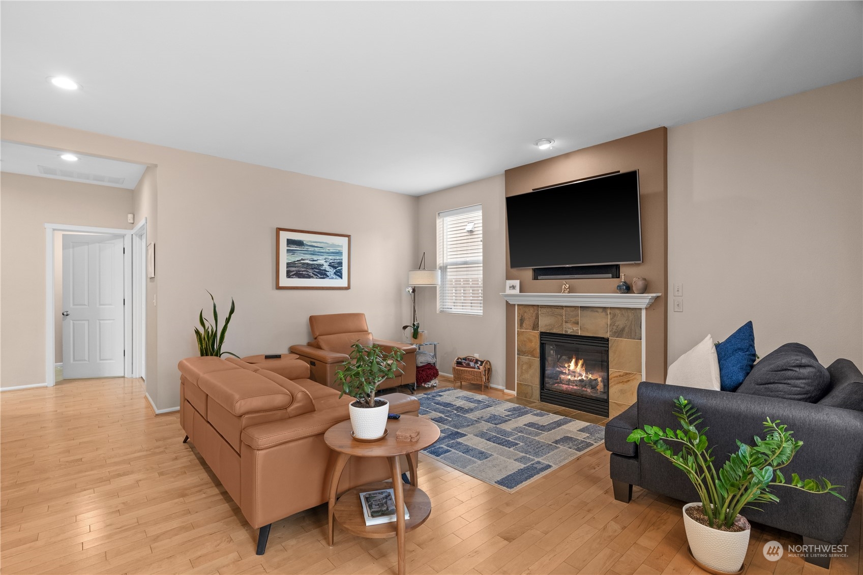 27325 Maple Ridge Way Southeast Maple Valley, WA 98038 - Photo 19 of 40 a living room with furniture a flat screen tv and a fireplace