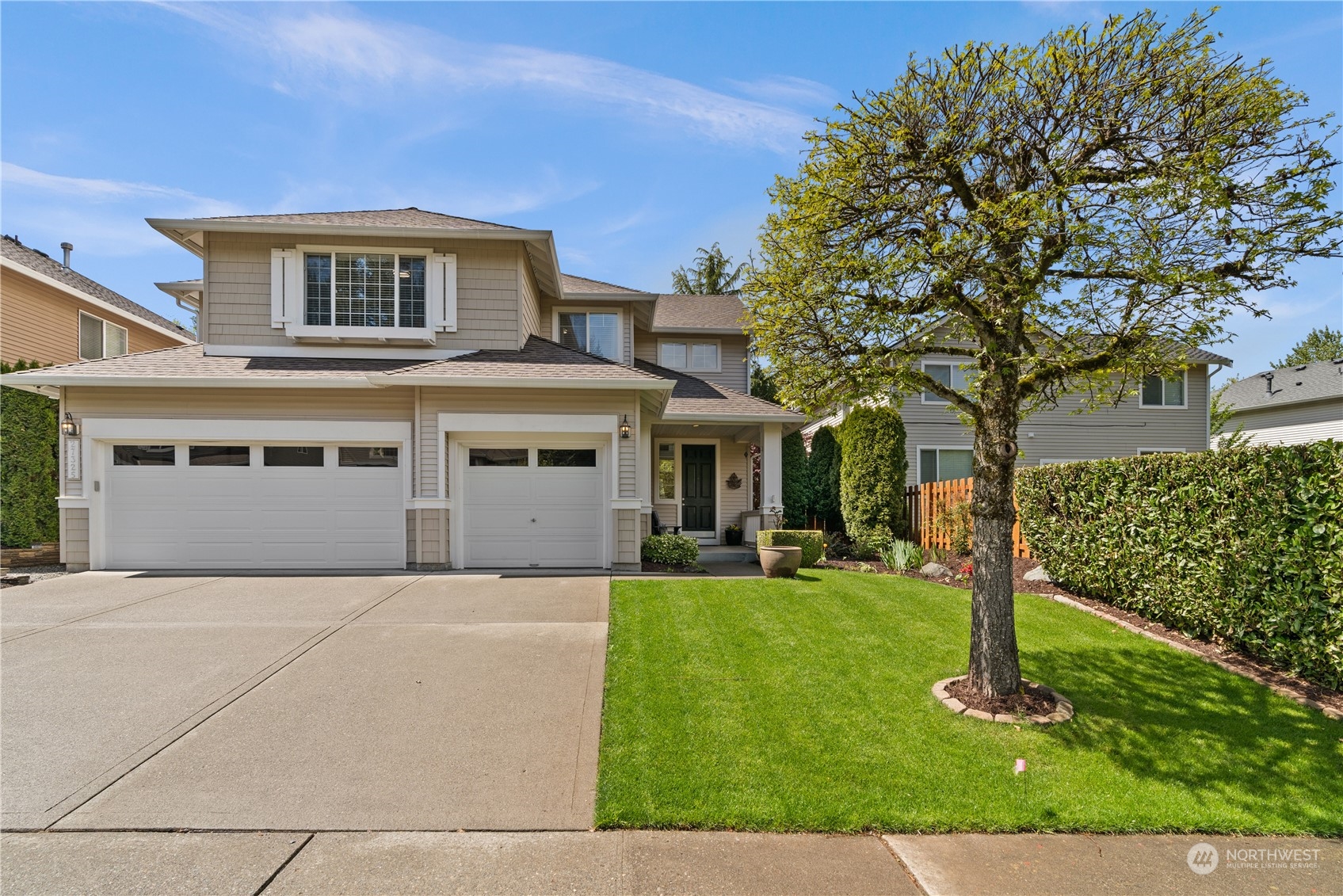 27325 Maple Ridge Way Southeast Maple Valley, WA 98038 - Photo 2 of 40 a front view of a house with a yard