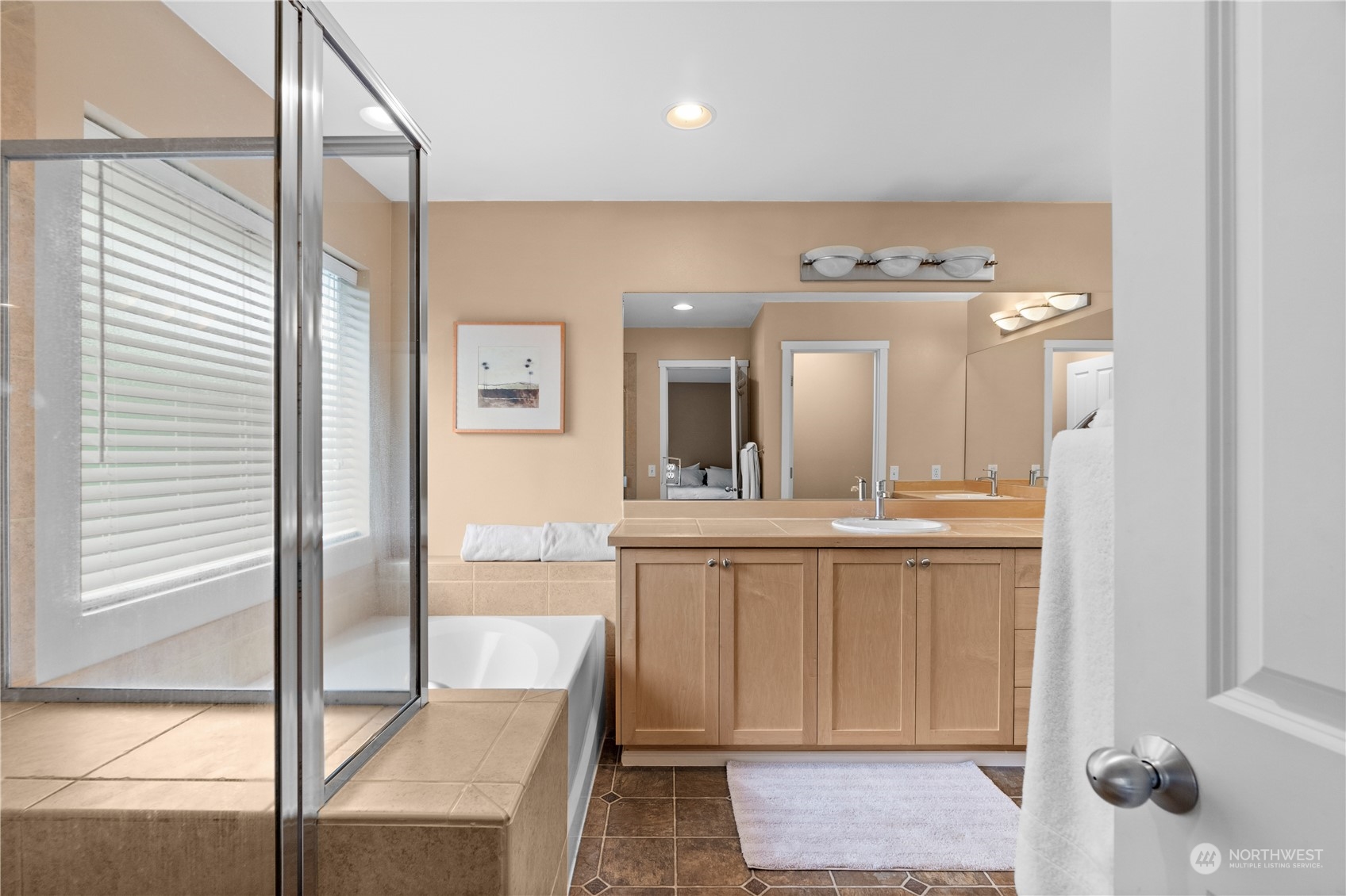 27325 Maple Ridge Way Southeast Maple Valley, WA 98038 - Photo 27 of 40 a bathroom with a tub a sink and mirrors