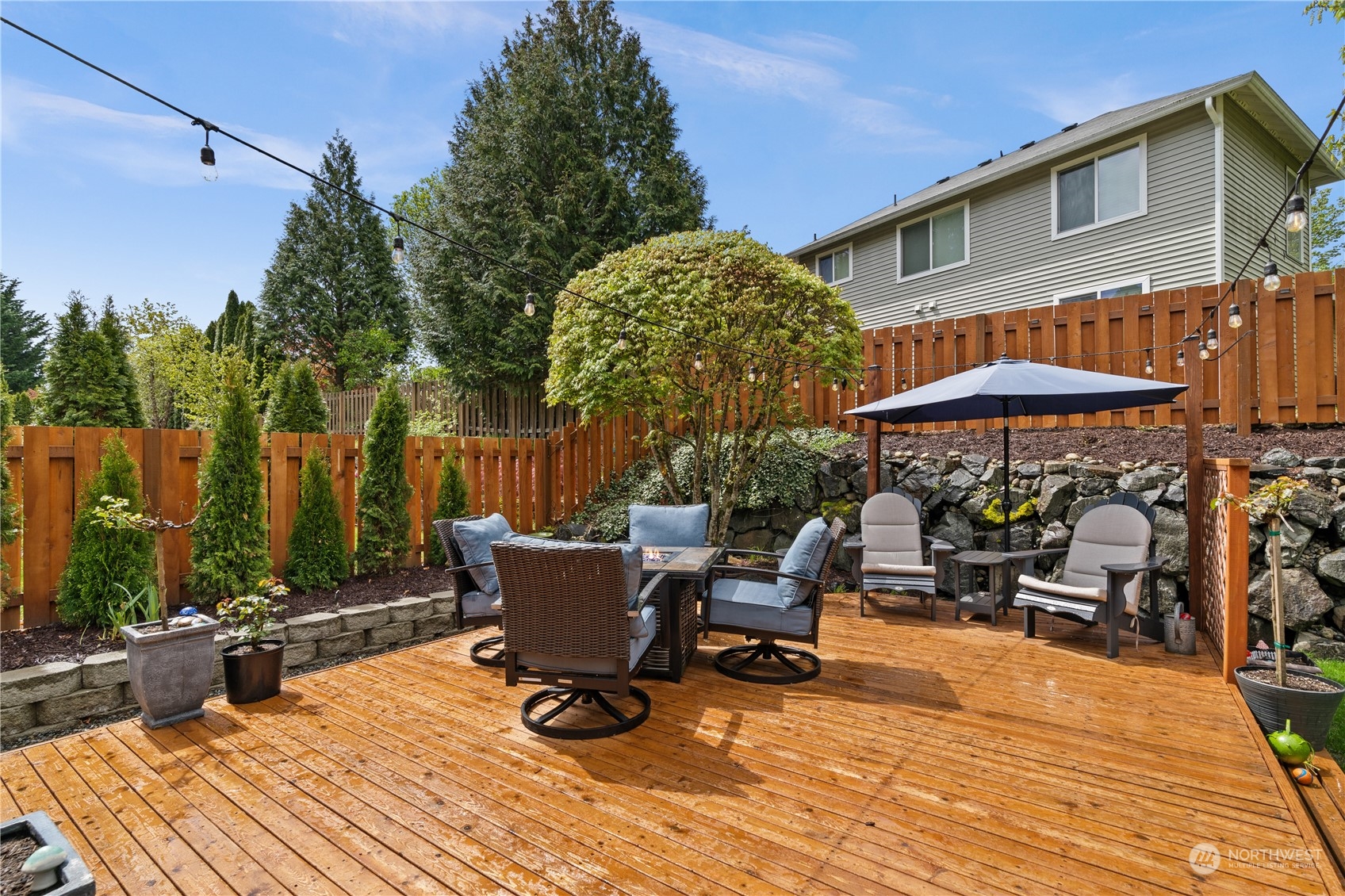 27325 Maple Ridge Way Southeast Maple Valley, WA 98038 - Photo 3 of 40 a view of a dinning tables and chairs in the patio in front of a house