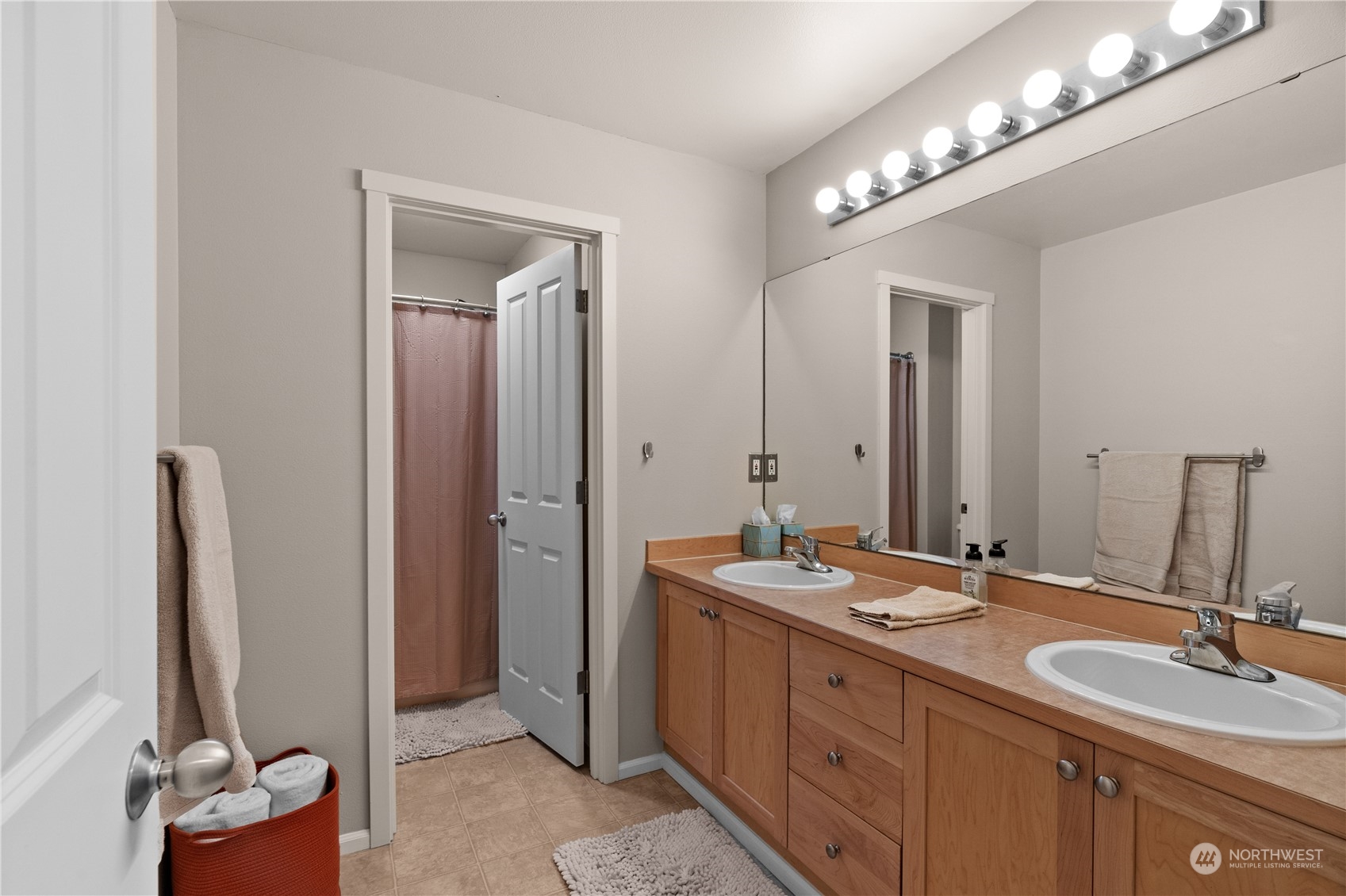 27325 Maple Ridge Way Southeast Maple Valley, WA 98038 - Photo 31 of 40 a bathroom with double vanity sinks and a mirror