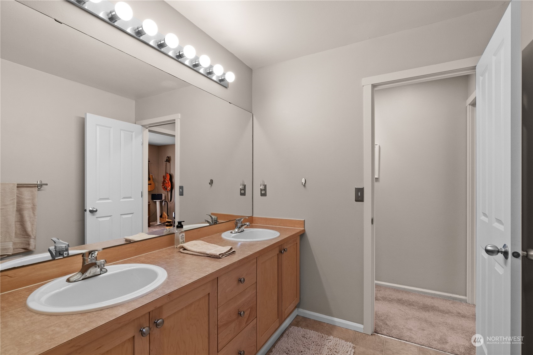 27325 Maple Ridge Way Southeast Maple Valley, WA 98038 - Photo 32 of 40 a bathroom with a sink double vanity and a mirror