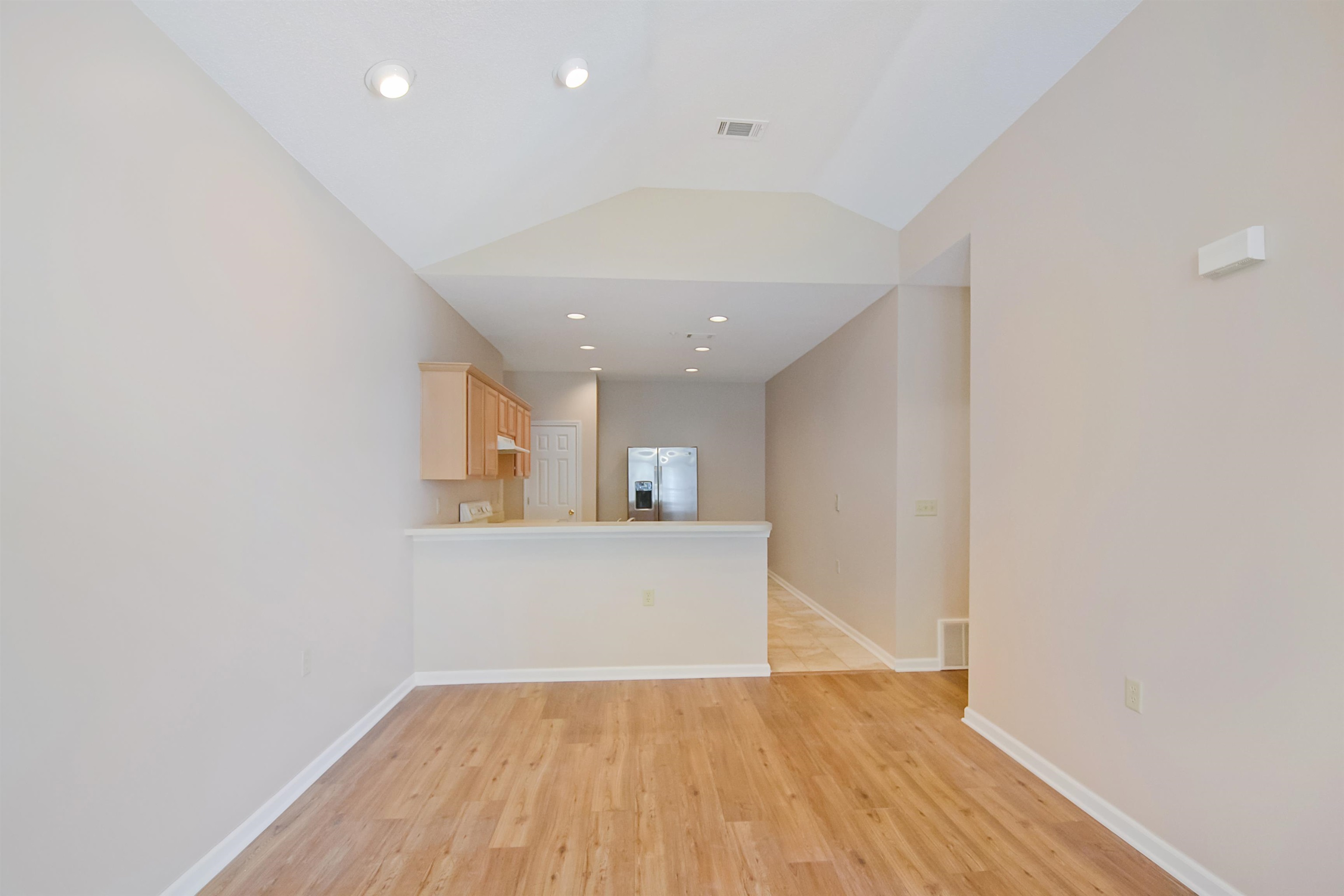 1201 Oak Timber Circle, Unit 29 Collierville, TN 38017 - Photo 11 of 32 a view of a kitchen with wooden floor and a ceiling fan