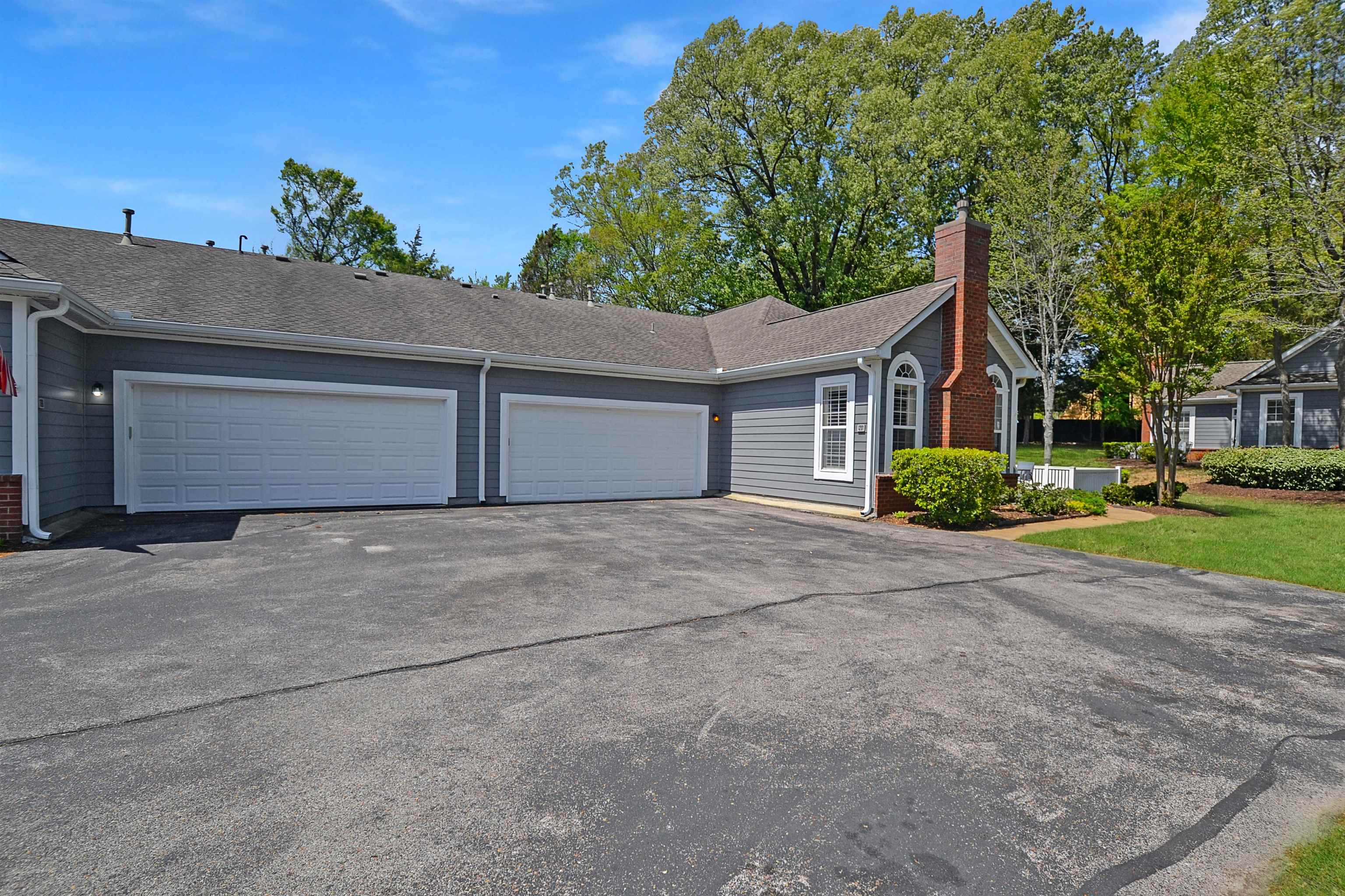 1201 Oak Timber Circle, Unit 29 Collierville, TN 38017 - Photo 2 of 32 a front view of a house with a yard and garage