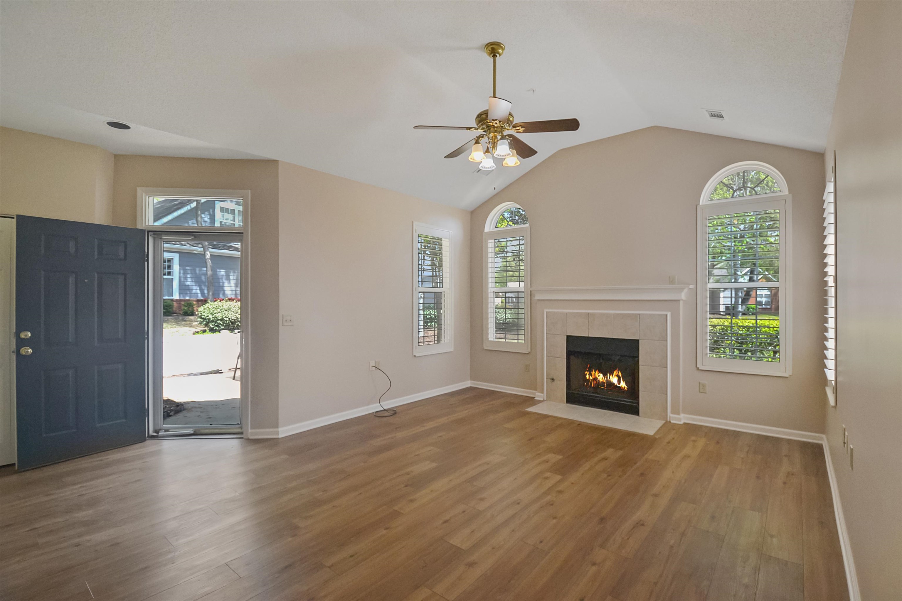 1201 Oak Timber Circle, Unit 29 Collierville, TN 38017 - Photo 4 of 32 an empty room with windows fireplace and wooden floor