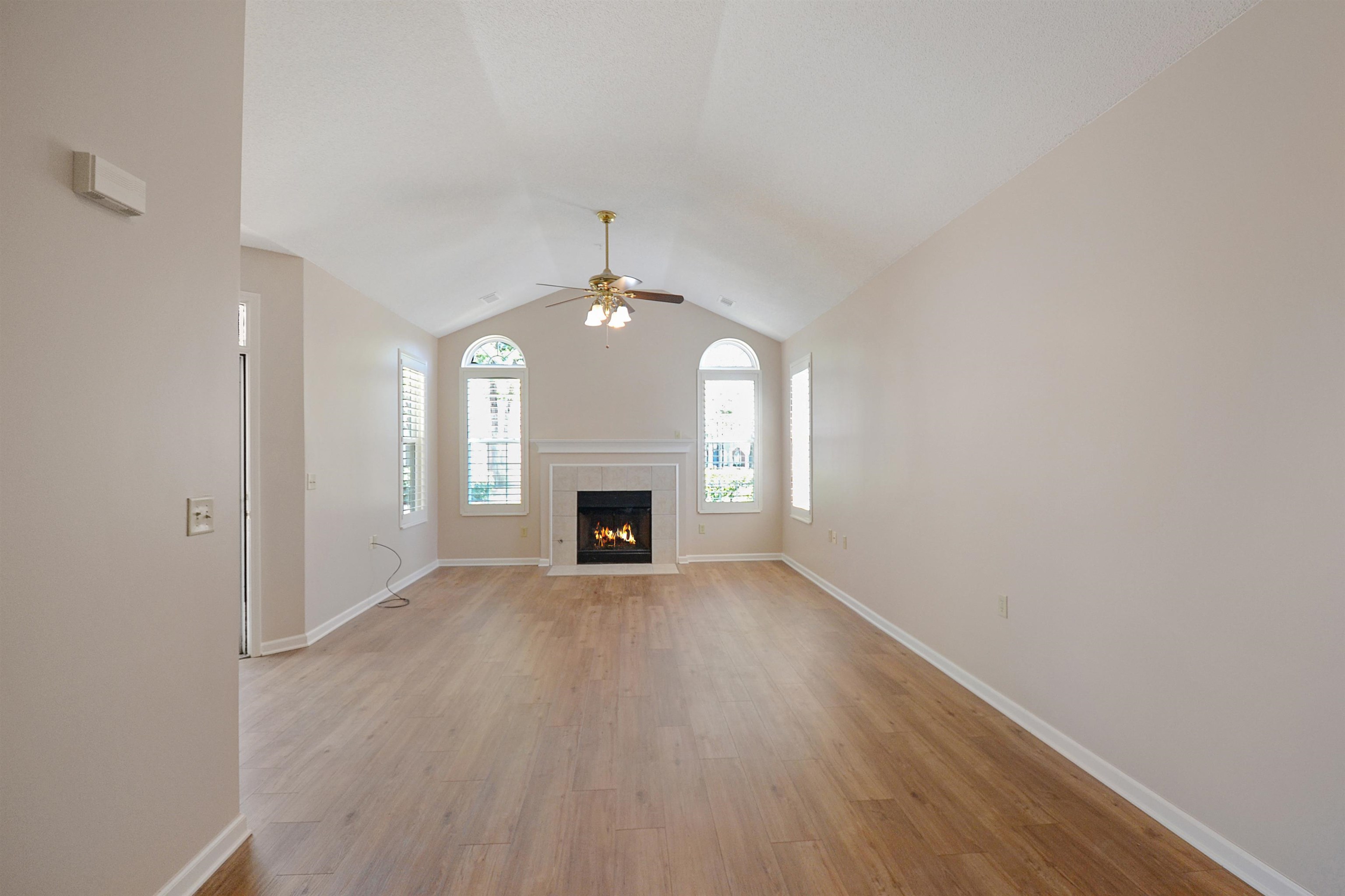 1201 Oak Timber Circle, Unit 29 Collierville, TN 38017 - Photo 6 of 32 an empty room with wooden floor fireplace and windows