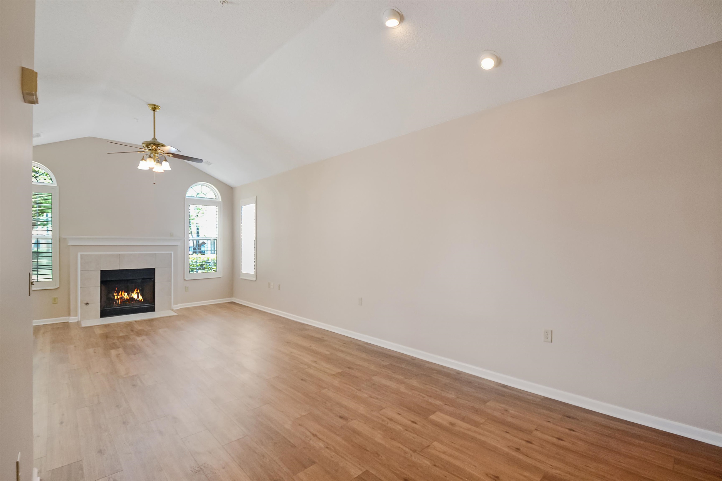 1201 Oak Timber Circle, Unit 29 Collierville, TN 38017 - Photo 9 of 32 a view of an empty room with wooden floor fireplace and a window
