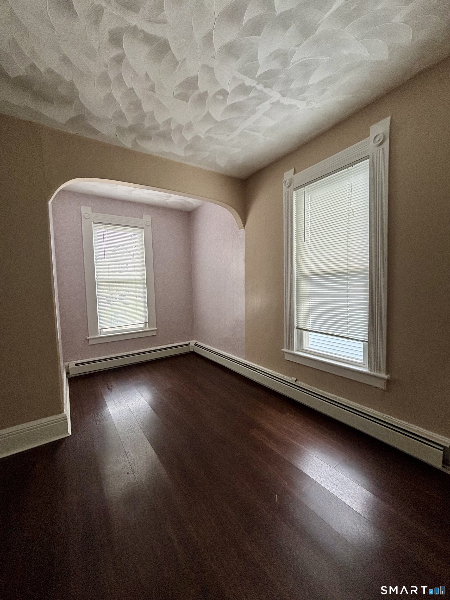 51-53 Cliff Street Norwich, CT 06360 - Photo 4 of 9 an empty room with wooden floor and windows