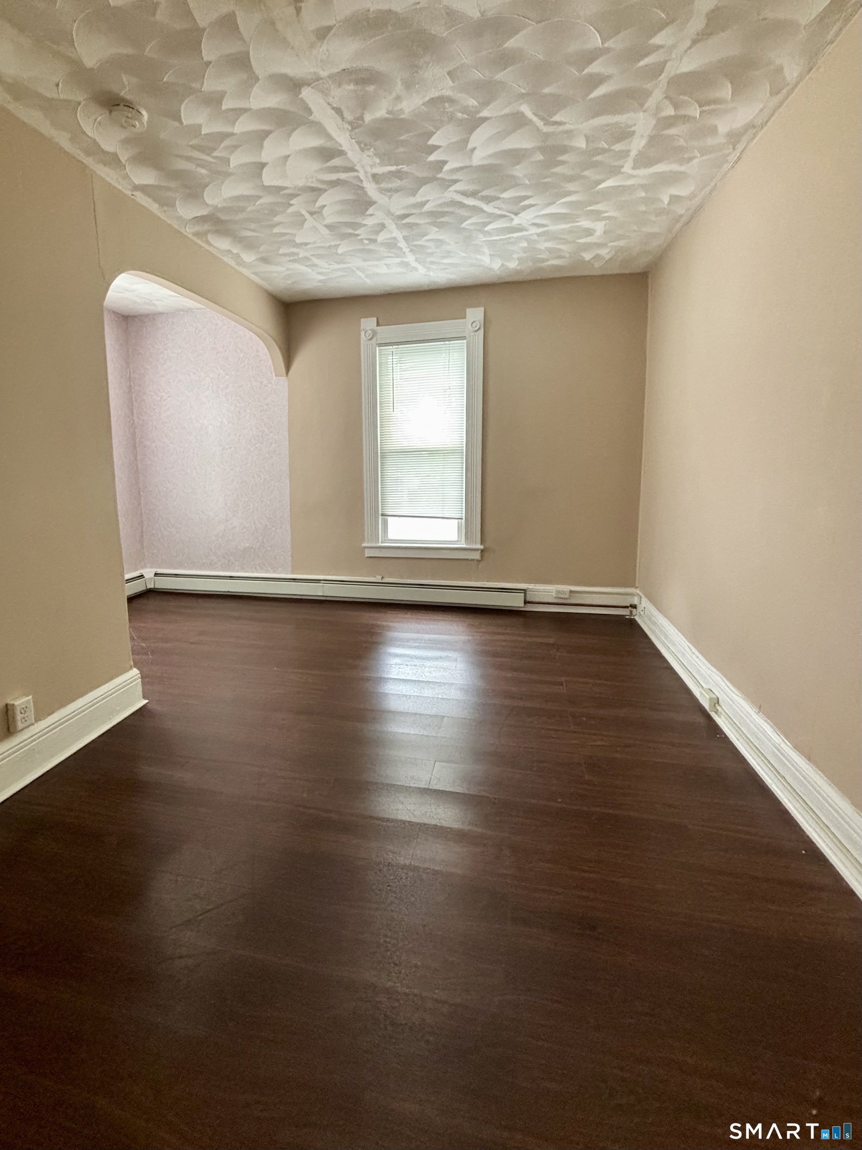 51-53 Cliff Street Norwich, CT 06360 - Photo 5 of 9 a view of an empty room with wooden floor and a window