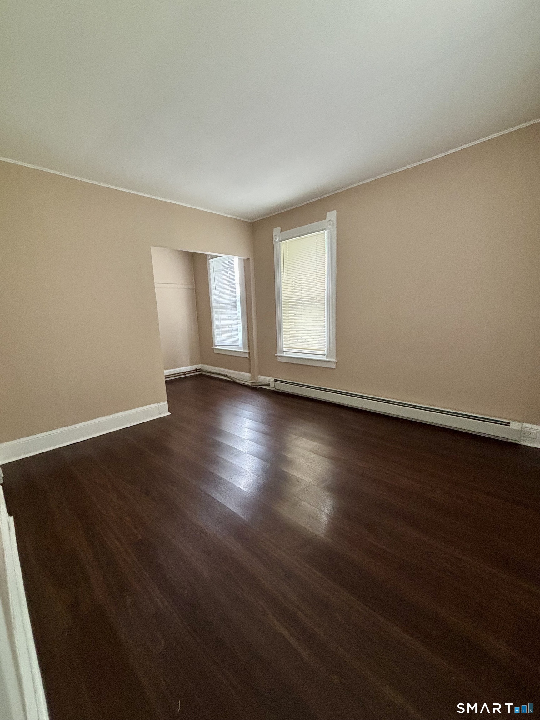 51-53 Cliff Street Norwich, CT 06360 - Photo 6 of 9 a view of an empty room with wooden floor and window