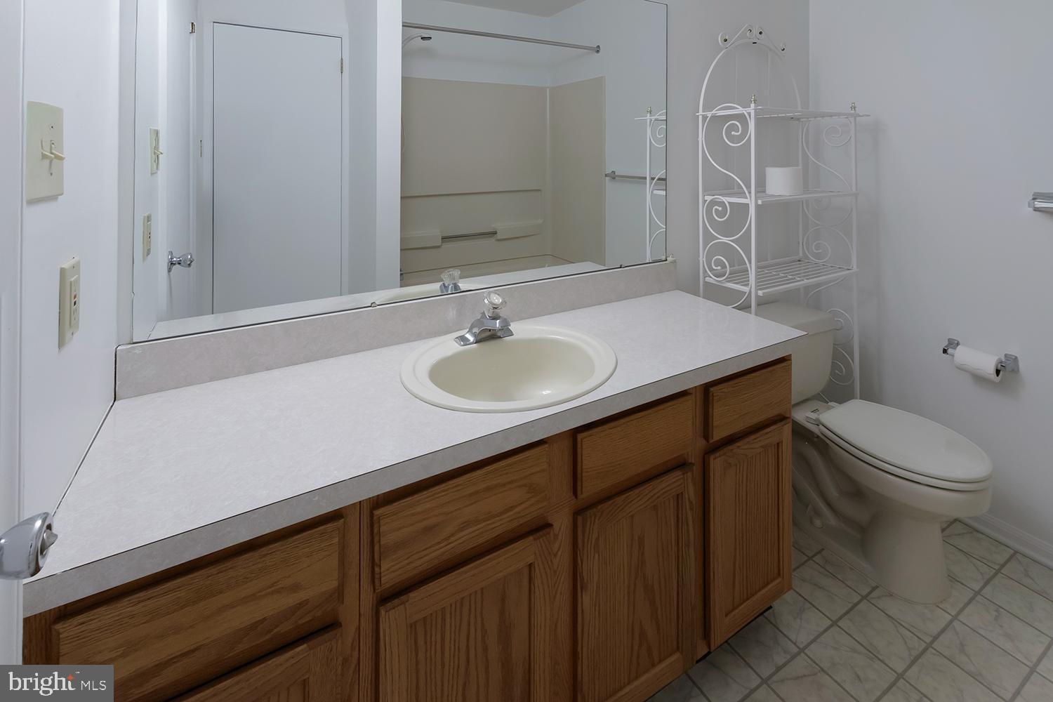 1602 Squirrel Road Marlton, NJ 08053 - Photo 13 of 21 a bathroom with a granite countertop sink a toilet and a mirror