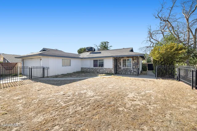 a front view of a house with a yard covered in snow
