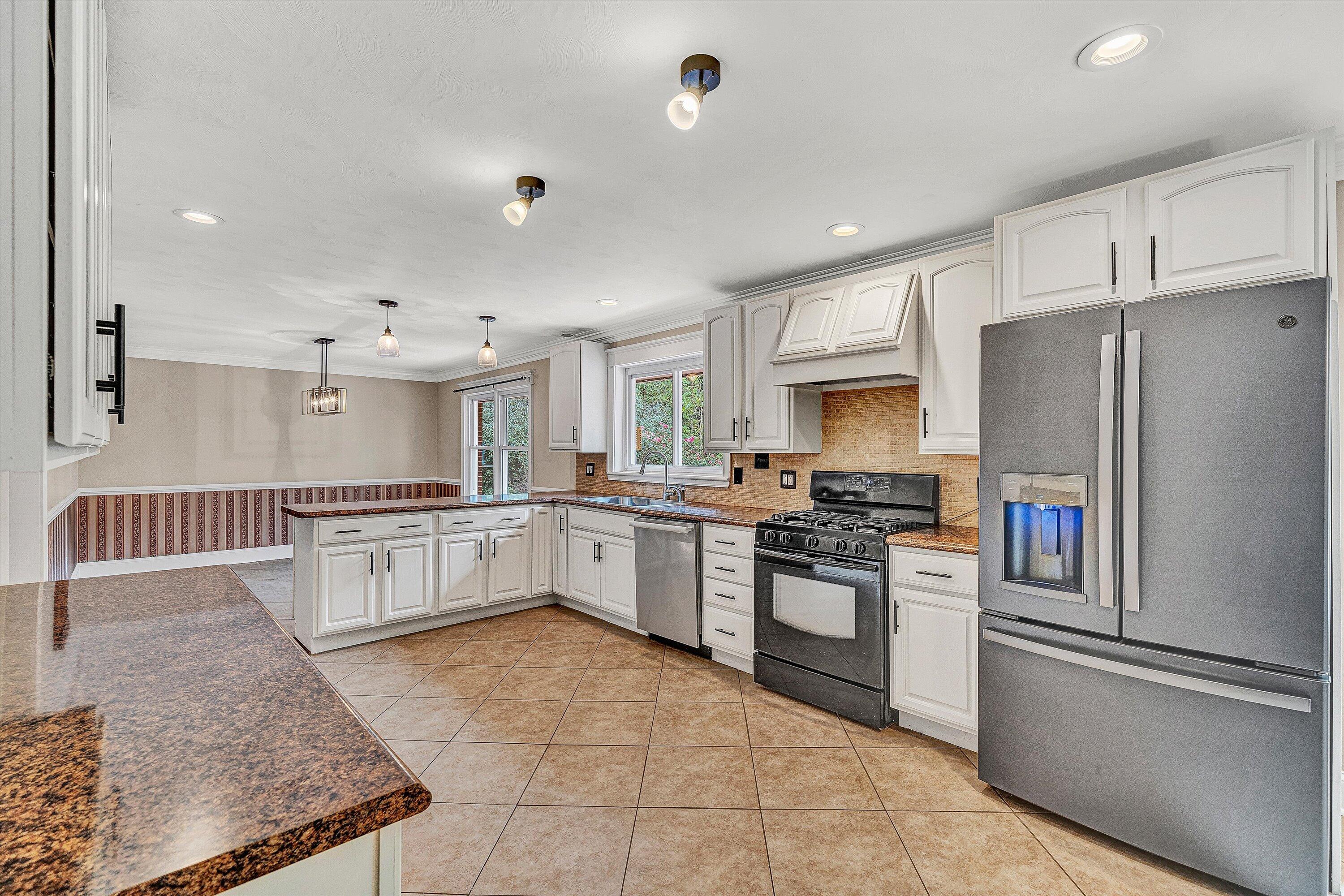 83 Springview Court Troutville, VA 24175 - Photo 15 of 74 a kitchen with stainless steel appliances granite countertop a refrigerator oven a sink dishwasher and white cabinets next to a window