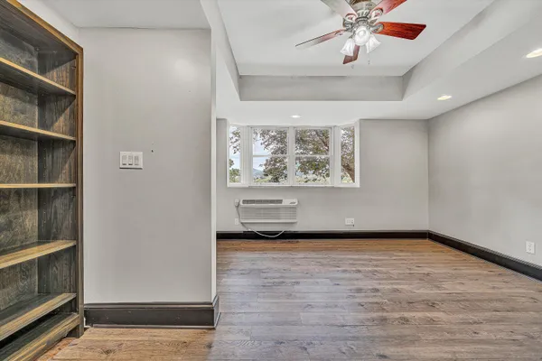 a view of a hallway with wooden floor