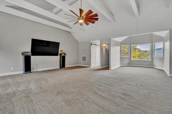 a view of a backyard with a garden and entertaining space