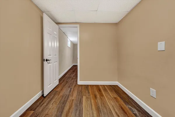 a view of swimming pool with lawn chairs and large trees