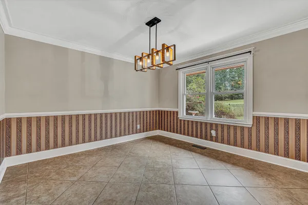 a kitchen with stainless steel appliances granite countertop a refrigerator oven a sink dishwasher and white cabinets next to a window