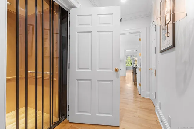 a view of a hallway with wooden floor and staircase