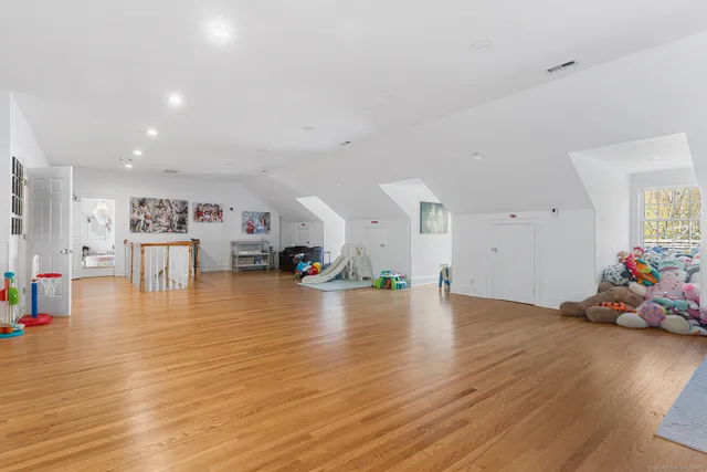 a room with wooden floors and lots of furniture
