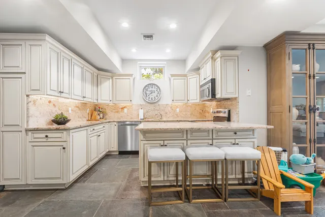 a kitchen with a sink cabinets and window