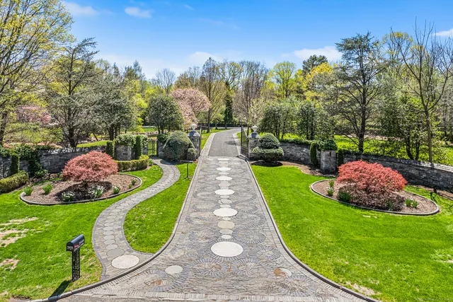 a view of a garden with a fountain in the background