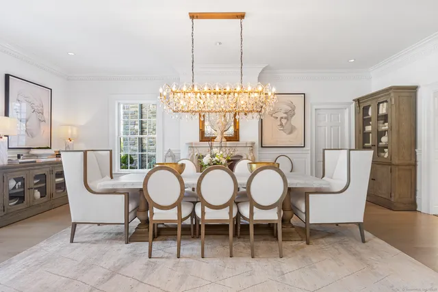 a view of a dining room with furniture and chandelier