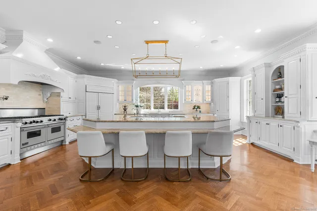 a large kitchen with a table and chairs in it