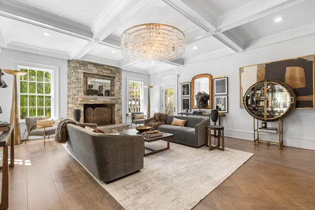 a living room with fireplace furniture and a large window