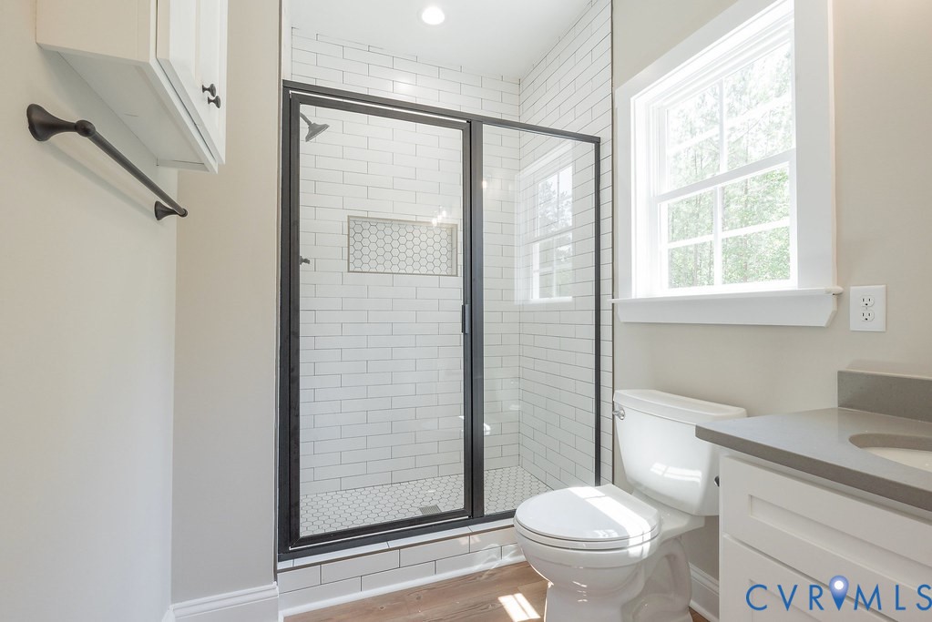 2349 Wickham Road Bumpass, VA 23024 - Photo 22 of 47 Bathroom with vanity, a stall shower, and wood fin