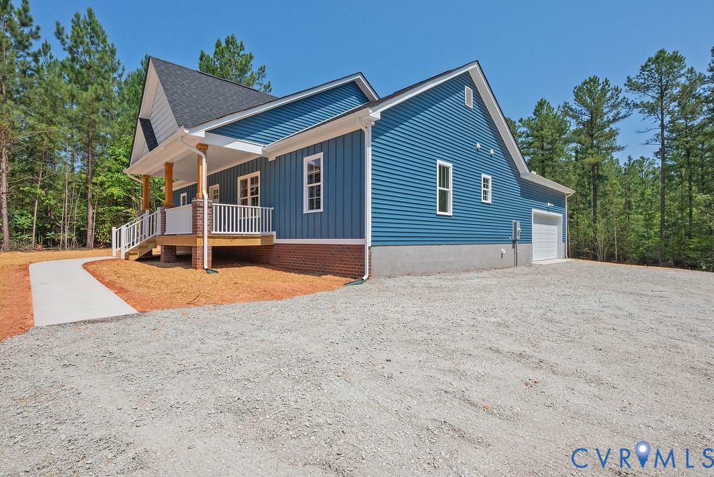 2349 Wickham Road Bumpass, VA 23024 - Photo 3 of 47 View of side of property featuring a porch, gravel