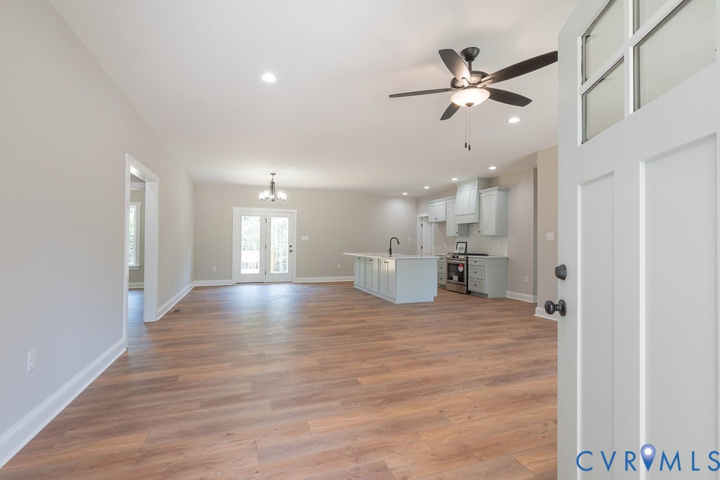 2349 Wickham Road Bumpass, VA 23024 - Photo 9 of 47 Unfurnished living room with light wood-style floo