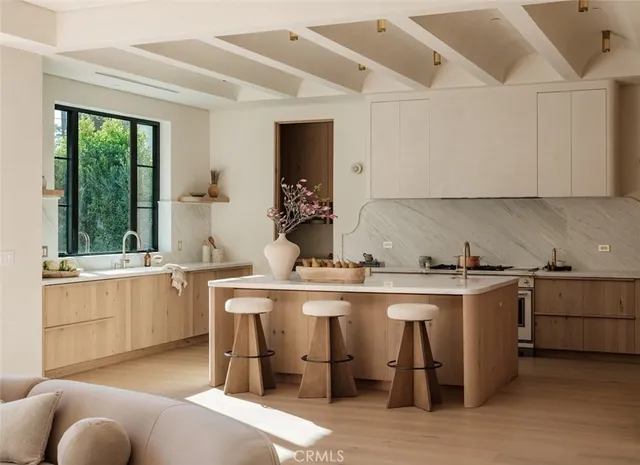 a kitchen with a sink and white cabinets