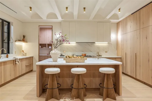 a kitchen with sink stove and cabinets