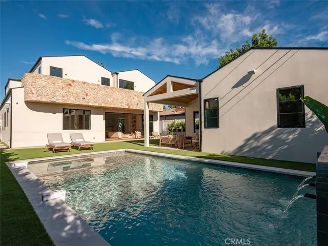 a spacious bedroom with a bed and large mirror