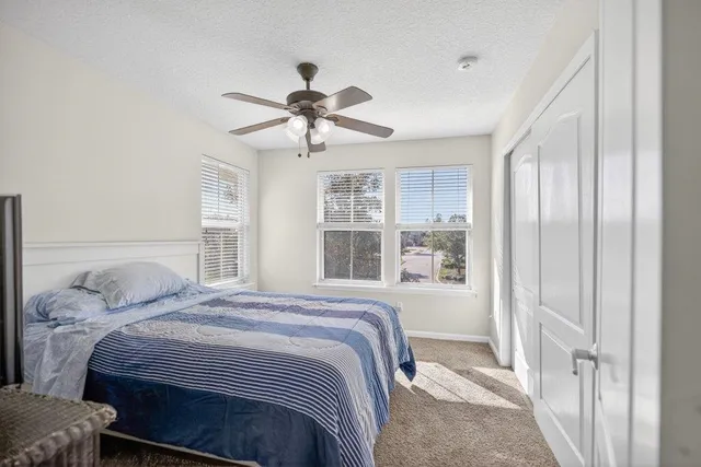 a bedroom with a large bed and a window