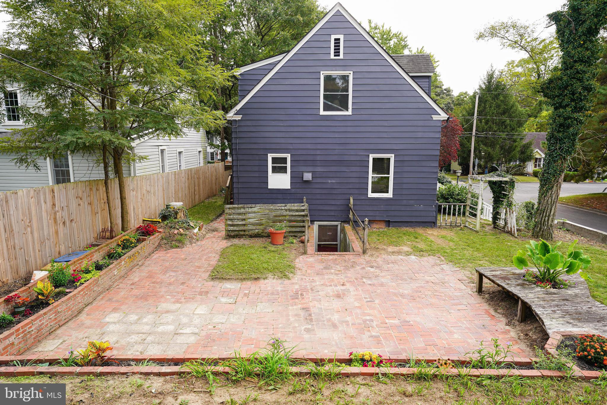 815 Federal Street Salisbury, MD 21801 - Photo 3 of 43 a view of a backyard with table and chairs plants and wooden fence