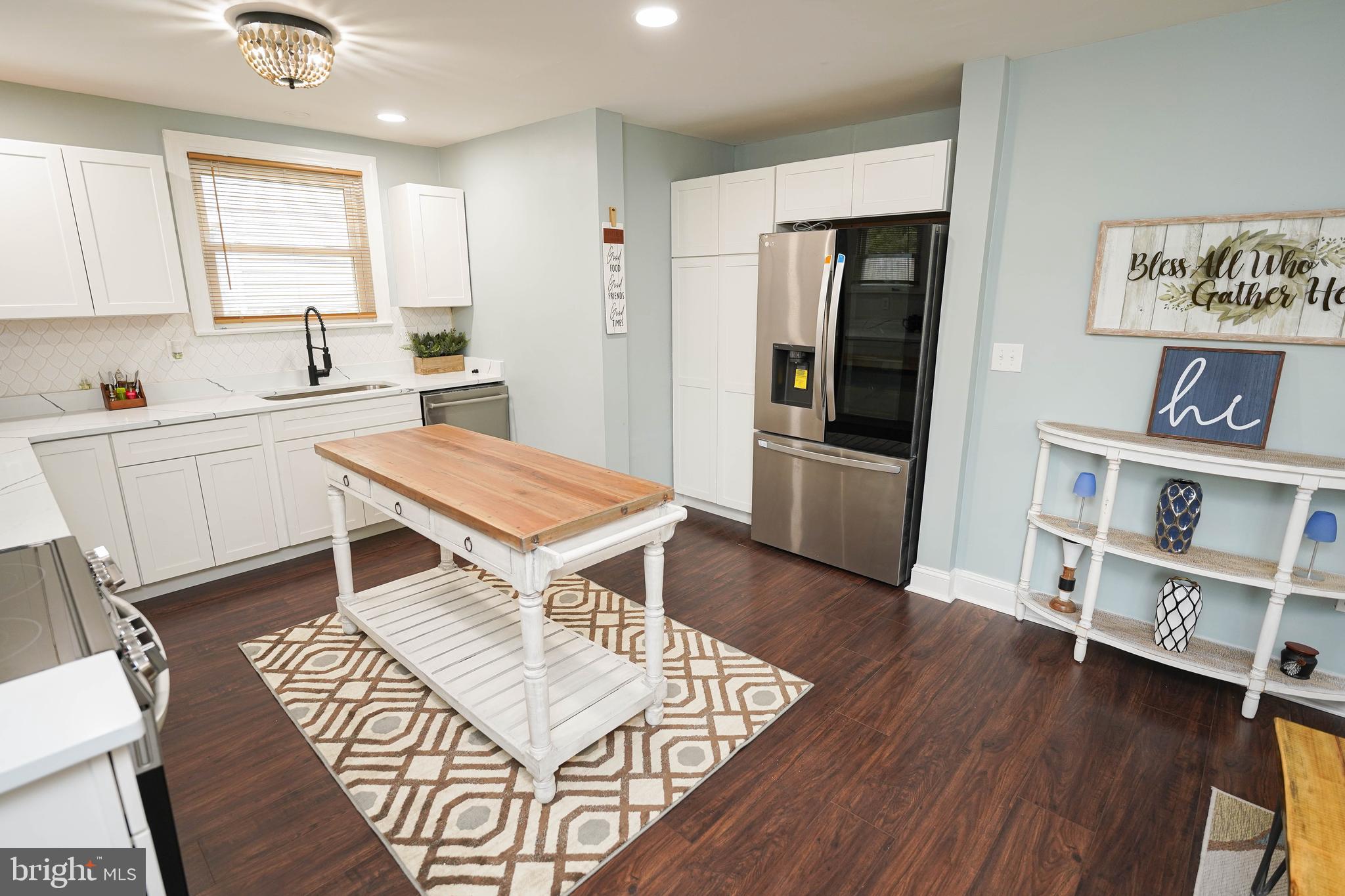 815 Federal Street Salisbury, MD 21801 - Photo 9 of 43 a kitchen with stainless steel appliances granite countertop a stove a sink dishwasher and a refrigerator with wooden floor